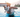 Man holding a Jack Russell Terrier in a swimming pool