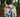 Woman cuddling her white Swiss Shepherd dog in a forest