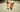 Two Golden Retrievers sitting on a paved path, one yawning