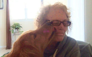 Woman lovingly embraces her Golden Retriever dog.  Jackie's love.