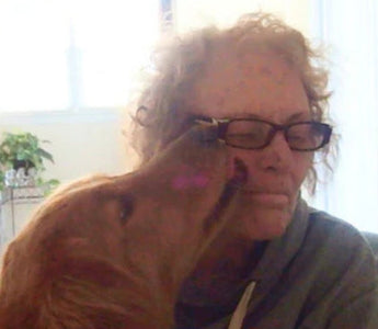 Woman lovingly embraces her Golden Retriever dog.  Jackie's love.