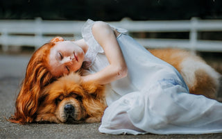 Red-haired girl sleeping peacefully with her fluffy dog