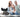 A Chinese Crested dog rests on a rug with a family blurred in the background.