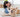 Happy woman playing with her Golden Retriever dog on a fluffy rug.