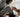Woman in face mask petting dog by window