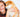 Happy young woman cuddling her Shiba Inu puppy.