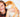 Happy young woman cuddling an adorable Shiba Inu puppy.