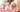 Girl and dog in Santa hats smile for Christmas photo