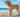 Golden Labrador Retriever on beach, holding tennis ball