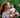 Young woman holding an adorable Siberian Husky puppy