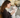 Woman gently holding white poodle, promoting pet wellness with PEMF therapy.