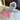 White dog lying on a bed with a pink plush toy next to it