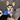 Dog wearing a Toronto Blue Jays bandana sitting on a couch.